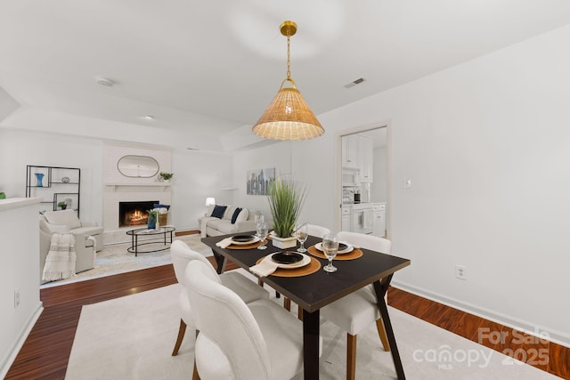 8806 Golf Ridge Dr, Charlotte, NC 28277 - dining area with dark wood-style flooring and a fireplace