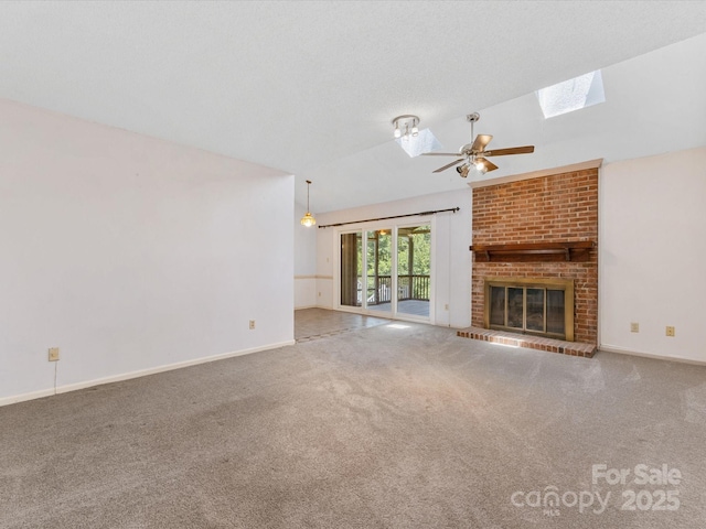 4601 Bournewood Ln, Charlotte, NC 28226 - unfurnished living room with a skylight, ceiling fan, lofted ceiling, carpet, and a brick fireplace