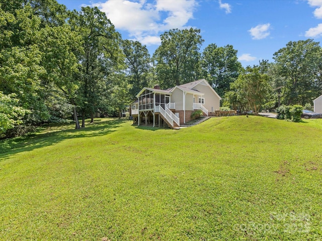 4601 Bournewood Ln, Charlotte, NC 28226 - view of grassy yard with stairway, a sunroom, and view of wooded area