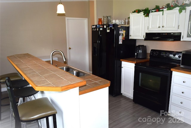 225 Emmett St, Rock Hill, SC 29730 - kitchen featuring black appliances, ventilation hood, a kitchen bar, and white cabinets