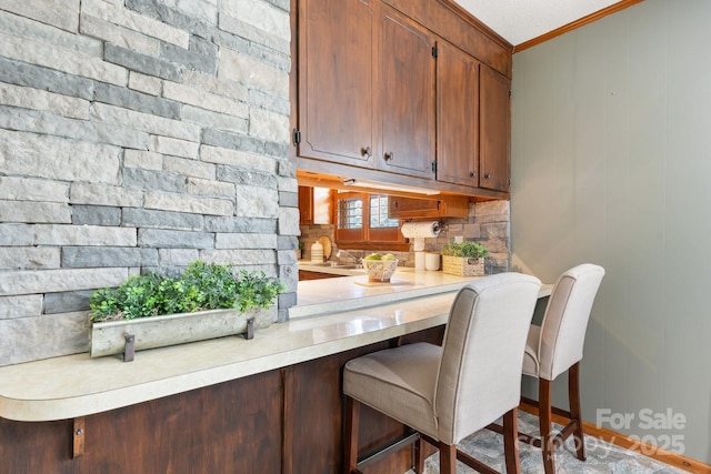 100 Pinecrest Ct, Taylorsville, NC 28681 - kitchen with ornamental molding, light countertops, and a kitchen bar