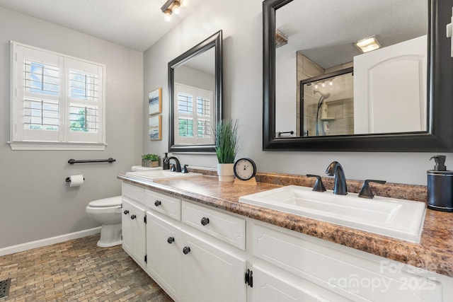 100 Pinecrest Ct, Taylorsville, NC 28681 - bathroom with double vanity, healthy amount of natural light, tiled shower, a textured ceiling, and brick patterned floors