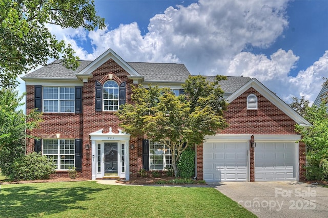 7930 Lancken Dr, Charlotte, NC 28277 - view of front of home featuring driveway, brick siding, a front lawn, and a garage
