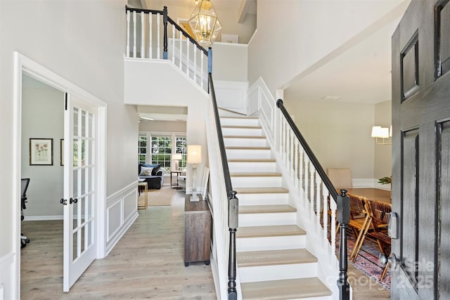 7930 Lancken Dr, Charlotte, NC 28277 - stairs with wood finished floors, a towering ceiling, a chandelier, and french doors
