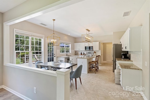 7930 Lancken Dr, Charlotte, NC 28277 - dining area featuring a chandelier and light floors