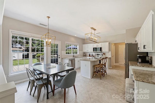 7930 Lancken Dr, Charlotte, NC 28277 - dining area featuring a chandelier and baseboards
