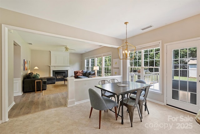 7930 Lancken Dr, Charlotte, NC 28277 - dining space featuring a chandelier, a large fireplace, and ceiling fan