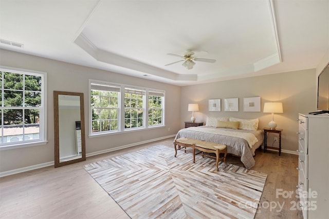 7930 Lancken Dr, Charlotte, NC 28277 - bedroom featuring a raised ceiling, light wood-style floors, and ceiling fan