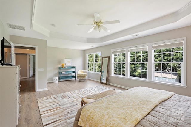 7930 Lancken Dr, Charlotte, NC 28277 - bedroom featuring a raised ceiling, light wood-style floors, crown molding, and a ceiling fan