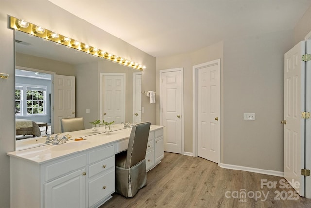 7930 Lancken Dr, Charlotte, NC 28277 - bathroom featuring double vanity, wood finished floors, and connected bathroom