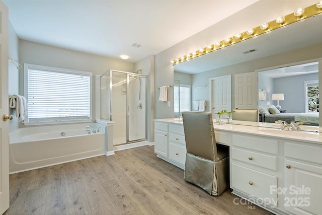 7930 Lancken Dr, Charlotte, NC 28277 - bathroom with a garden tub, vanity, wood finished floors, a shower stall, and ensuite bath