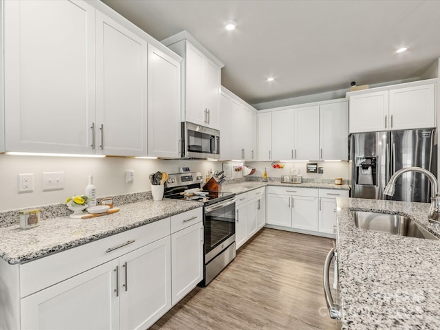510 Park Meadows Dr, Matthews, NC 28104 - kitchen featuring stainless steel appliances, white cabinetry, recessed lighting, and light stone countertops