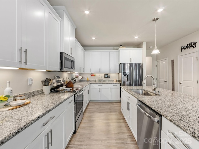 510 Park Meadows Dr, Matthews, NC 28104 - kitchen featuring stainless steel appliances, white cabinetry, recessed lighting, light stone counters, and light wood-style flooring