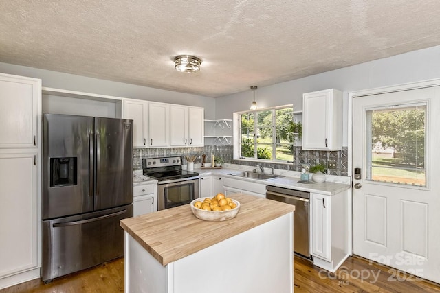 39 Nix Rd, Hendersonville, NC 28792 - kitchen featuring stainless steel appliances, wooden counters, open shelves, white cabinetry, and tasteful backsplash