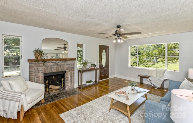 39 Nix Rd, Hendersonville, NC 28792 - living area featuring ceiling fan, wood finished floors, a textured ceiling, and a brick fireplace