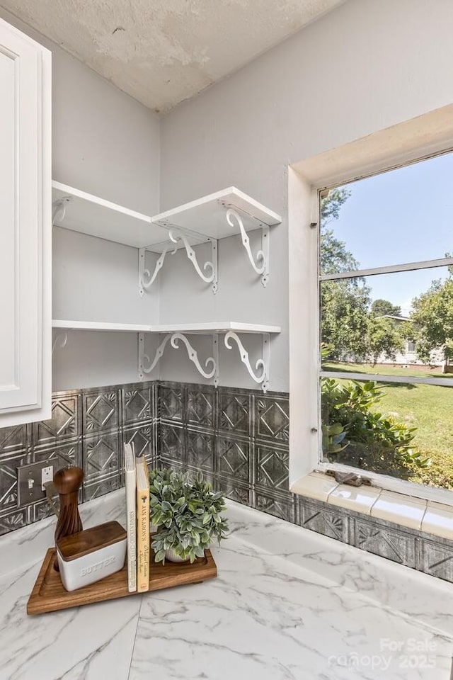 39 Nix Rd, Hendersonville, NC 28792 - interior space with open shelves, tasteful backsplash, white cabinetry, and light stone counters