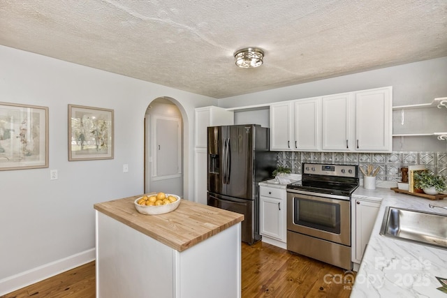 39 Nix Rd, Hendersonville, NC 28792 - kitchen featuring electric range, black fridge, open shelves, tasteful backsplash, and white cabinetry
