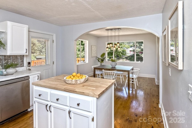 39 Nix Rd, Hendersonville, NC 28792 - kitchen featuring stainless steel dishwasher, white cabinets, wood finished floors, arched walkways, and pendant lighting