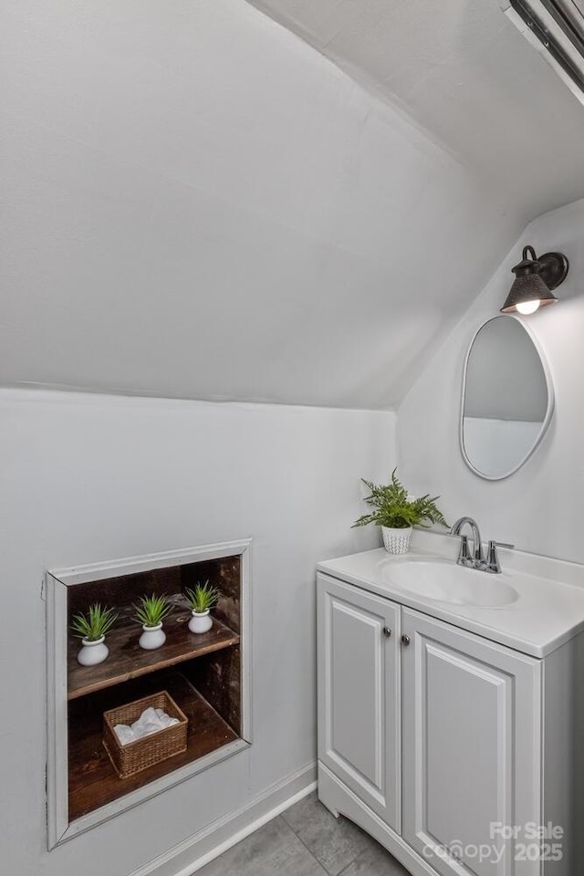 39 Nix Rd, Hendersonville, NC 28792 - bathroom with vaulted ceiling, vanity, and tile patterned floors