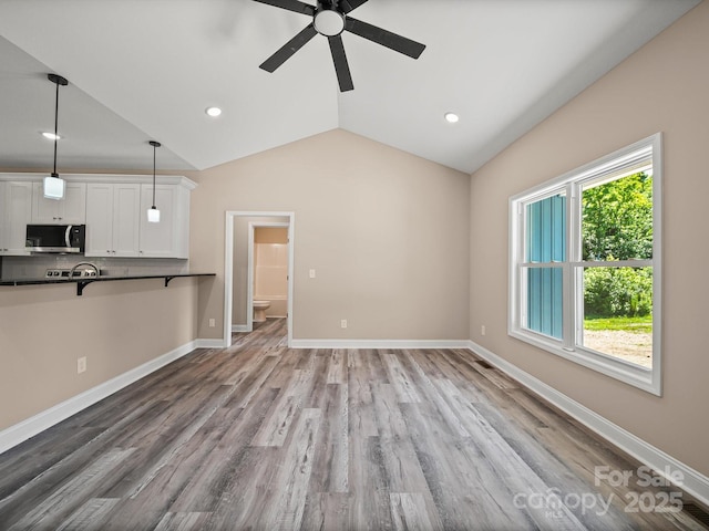 205 S Hill Ave, Albemarle, NC 28001 - unfurnished living room with ceiling fan, lofted ceiling, wood finished floors, and recessed lighting
