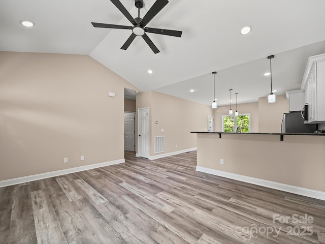 205 S Hill Ave, Albemarle, NC 28001 - unfurnished living room with a ceiling fan, wood finished floors, recessed lighting, and lofted ceiling