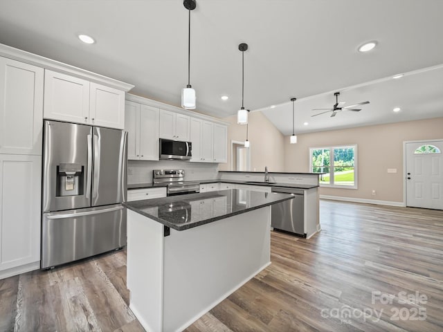 205 S Hill Ave, Albemarle, NC 28001 - kitchen with stainless steel appliances, a peninsula, wood finished floors, white cabinets, and recessed lighting