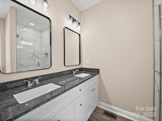 205 S Hill Ave, Albemarle, NC 28001 - full bath featuring a marble finish shower, double vanity, and wood finished floors