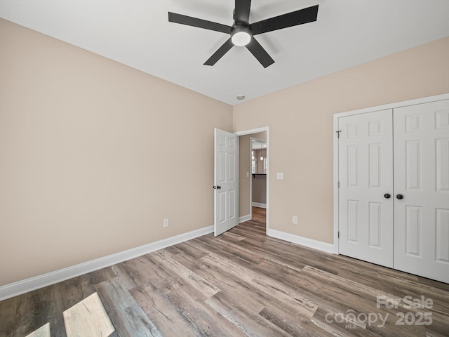 205 S Hill Ave, Albemarle, NC 28001 - unfurnished bedroom featuring wood finished floors, a closet, and a ceiling fan