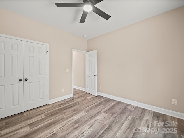 205 S Hill Ave, Albemarle, NC 28001 - unfurnished bedroom with wood finished floors, a closet, and a ceiling fan
