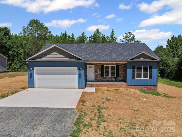 205 S Hill Ave, Albemarle, NC 28001 - ranch-style home featuring concrete driveway, a garage, covered porch, and board and batten siding