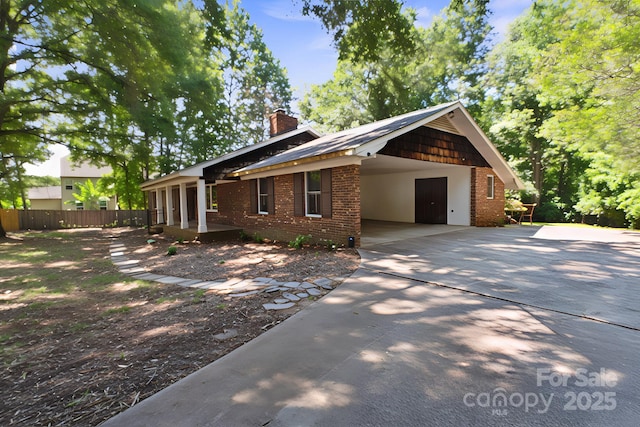 10120 Withers Rd, Charlotte, NC 28278 - view of front of property featuring brick siding, a chimney, driveway, and a carport