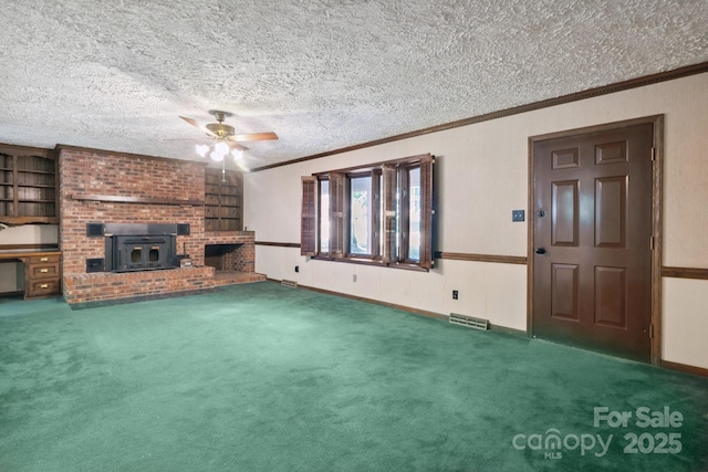 10120 Withers Rd, Charlotte, NC 28278 - unfurnished living room featuring ornamental molding, ceiling fan, carpet flooring, a textured ceiling, and a wood stove