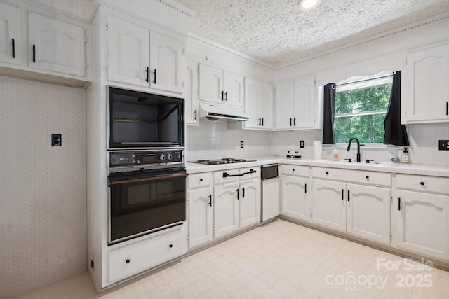 10120 Withers Rd, Charlotte, NC 28278 - kitchen featuring black appliances, white cabinetry, under cabinet range hood, decorative backsplash, and wallpapered walls
