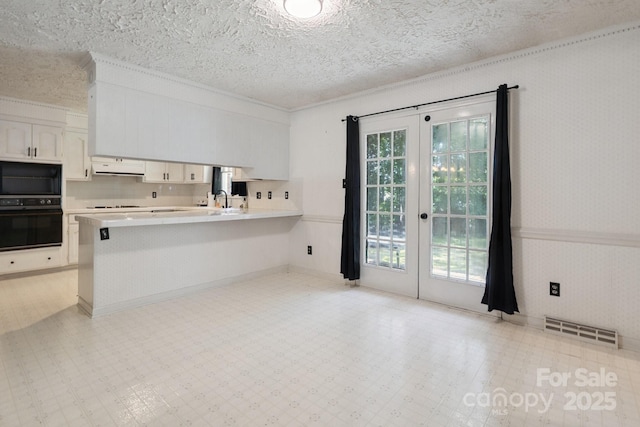 10120 Withers Rd, Charlotte, NC 28278 - kitchen with black appliances, french doors, exhaust hood, light countertops, and white cabinets