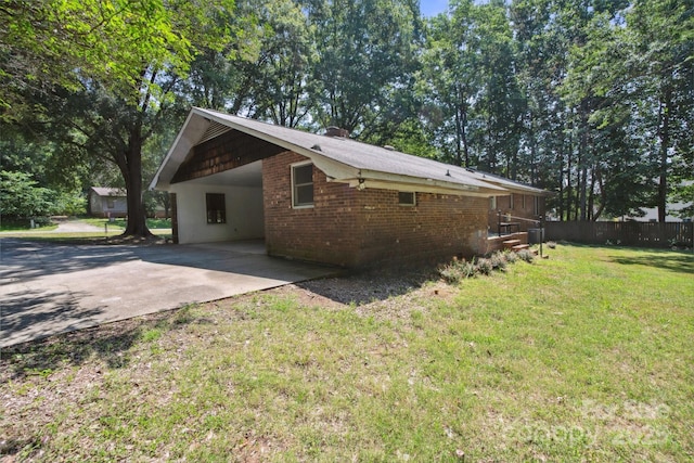 10120 Withers Rd, Charlotte, NC 28278 - view of property exterior featuring driveway, an attached carport, and brick siding