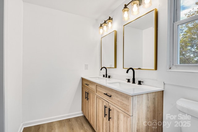 250 Franklin Ave NW, Concord, NC 28025 - bathroom with double vanity, plenty of natural light, and wood finished floors