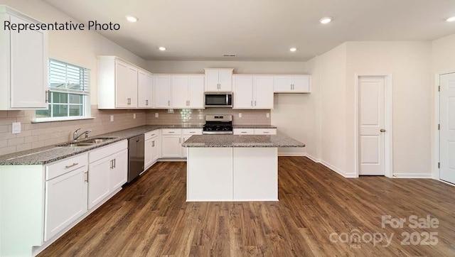 9223 Poquoson Dr, Gastonia, NC 28056 - kitchen featuring stainless steel appliances, dark stone countertops, tasteful backsplash, white cabinetry, and recessed lighting