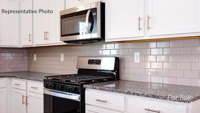 9223 Poquoson Dr, Gastonia, NC 28056 - kitchen with appliances with stainless steel finishes, white cabinetry, tasteful backsplash, and dark stone countertops