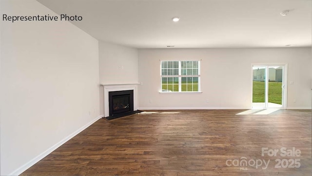 9223 Poquoson Dr, Gastonia, NC 28056 - unfurnished living room with a fireplace with flush hearth, dark wood finished floors, and recessed lighting