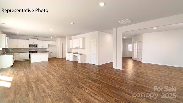 9223 Poquoson Dr, Gastonia, NC 28056 - unfurnished living room with dark wood-style floors and recessed lighting