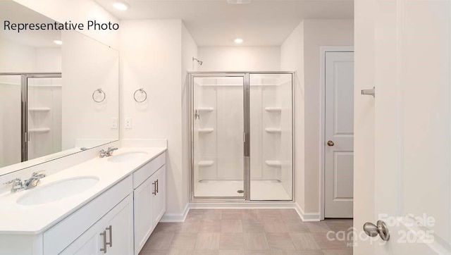 9223 Poquoson Dr, Gastonia, NC 28056 - bathroom with a stall shower, double vanity, tile patterned floors, and recessed lighting