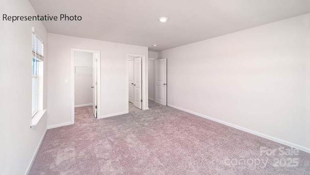 9223 Poquoson Dr, Gastonia, NC 28056 - unfurnished bedroom with carpet floors and a walk in closet