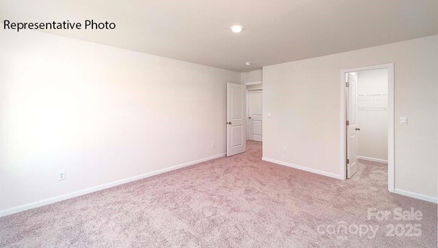 9223 Poquoson Dr, Gastonia, NC 28056 - unfurnished bedroom with a walk in closet and carpet floors