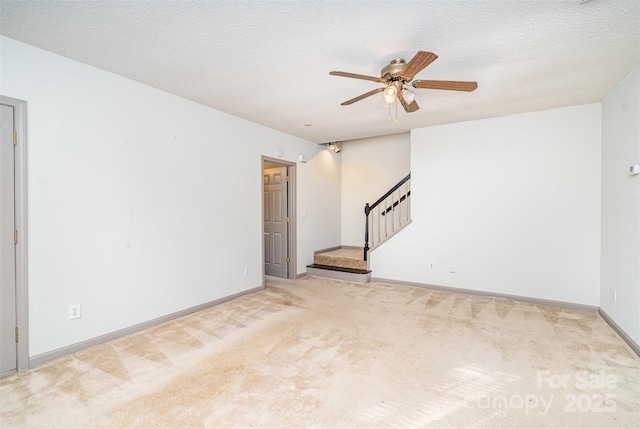 3630 Melrose Cottage Dr, Matthews, NC 28105 - carpeted empty room with stairway, ceiling fan, and a textured ceiling