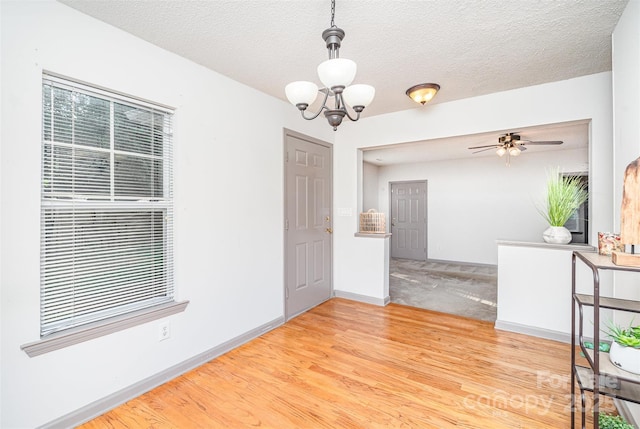 3630 Melrose Cottage Dr, Matthews, NC 28105 - unfurnished room with a chandelier, wood finished floors, ceiling fan, and a textured ceiling