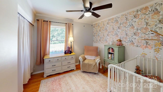 304 Sowers Ferry Rd, Salisbury, NC 28144 - bedroom with a nursery area, crown molding, wainscoting, light wood-style floors, and ceiling fan