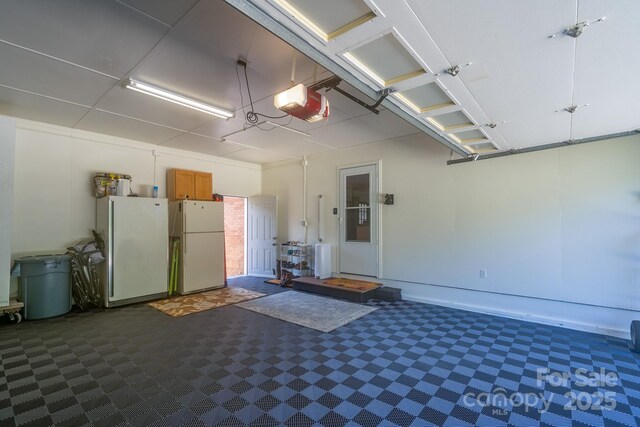 304 Sowers Ferry Rd, Salisbury, NC 28144 - garage featuring freestanding refrigerator and a garage door opener