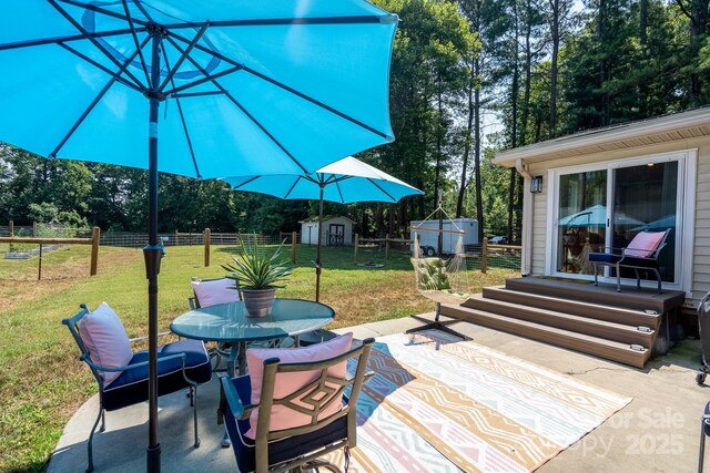 304 Sowers Ferry Rd, Salisbury, NC 28144 - view of patio / terrace with a storage shed, outdoor dining space, and view of wooded area