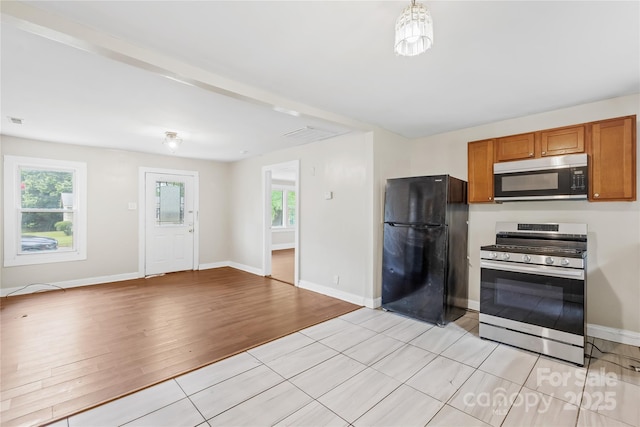 716 Wilson Rd, Salisbury, NC 28144 - kitchen featuring stainless steel appliances, brown cabinets, plenty of natural light, and open floor plan