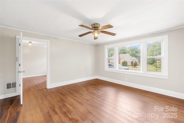 716 Wilson Rd, Salisbury, NC 28144 - empty room featuring wood finished floors, ceiling fan, and ornamental molding
